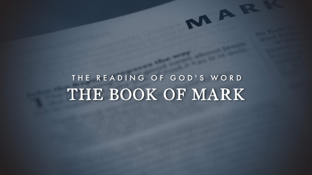 A Bible page with the title THE BOOK OF MARK in large text and THE READING OF GODS WORD above it. The word MARK is visible at the top, with the rest of the page blurred.