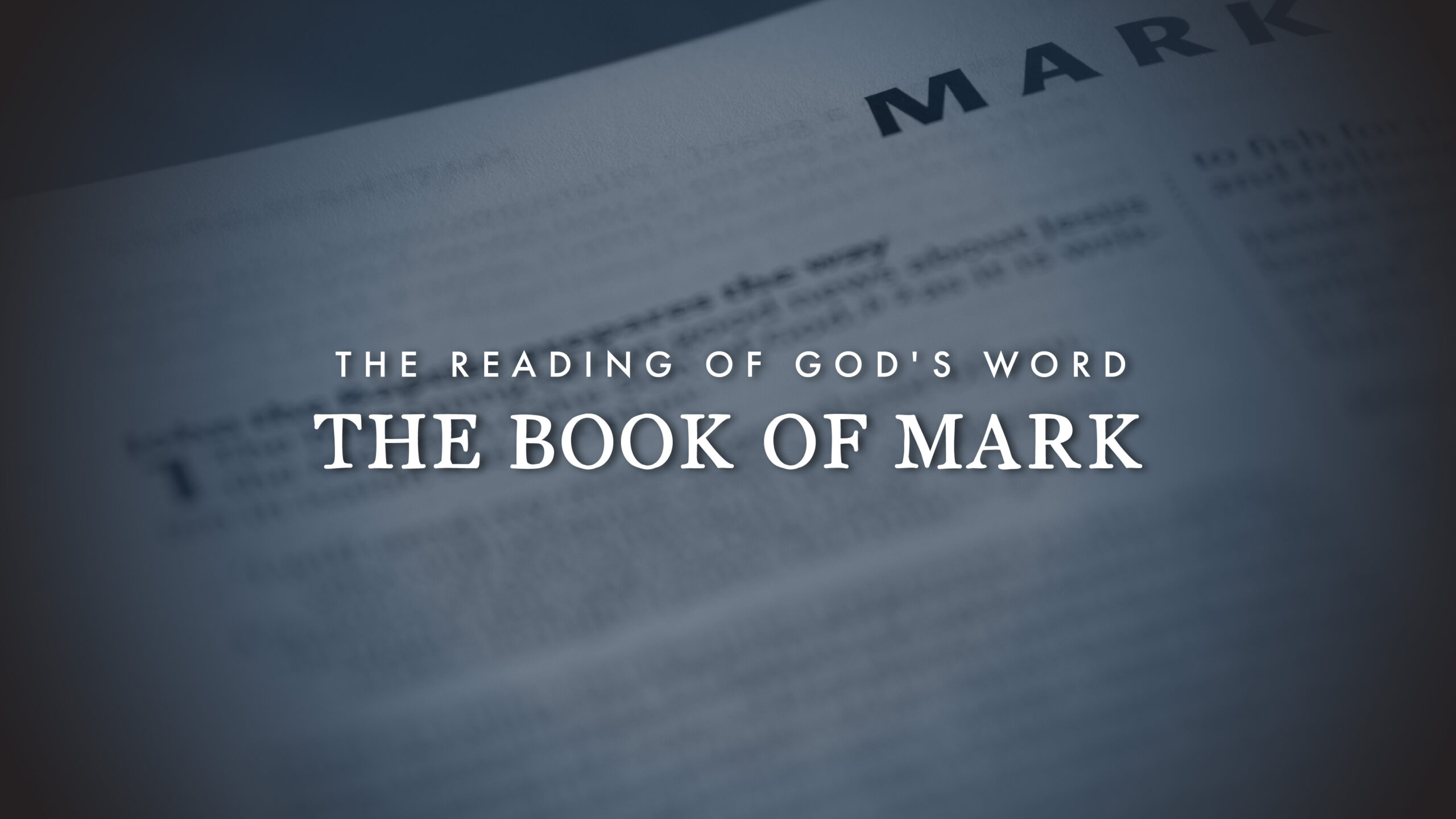 A Bible page with the title THE BOOK OF MARK in large text and THE READING OF GODS WORD above it. The word MARK is visible at the top, with the rest of the page blurred.