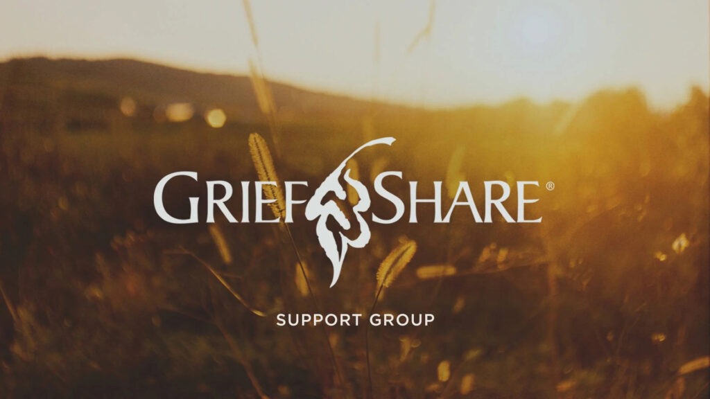 A golden field at sunset with hills in the background. The text GriefShare Support Group and a leaf logo are displayed in the center.