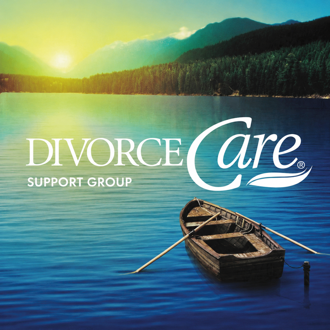 A wooden rowboat floats on a calm blue lake at sunset, surrounded by mountains and trees. The text reads DivorceCare Support Group.
